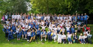 Large group shot of people sitting down on grass